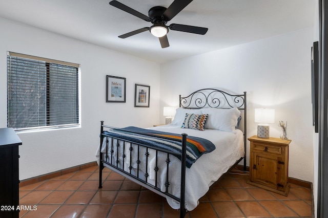 bedroom with dark tile patterned flooring and ceiling fan