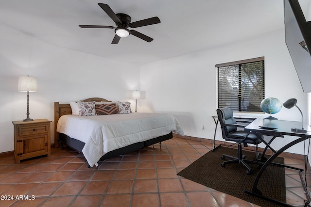 tiled bedroom featuring ceiling fan