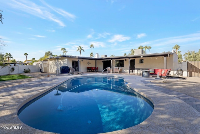 view of pool featuring a patio area and a grill