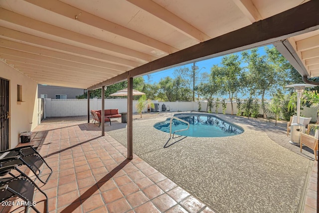 view of swimming pool with an outdoor living space and a patio area