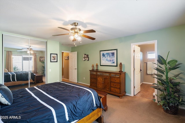 bedroom with light carpet, ceiling fan, and a closet