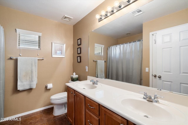 bathroom featuring tile patterned flooring, vanity, and toilet