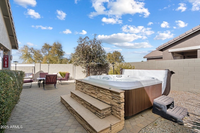 view of patio with a hot tub