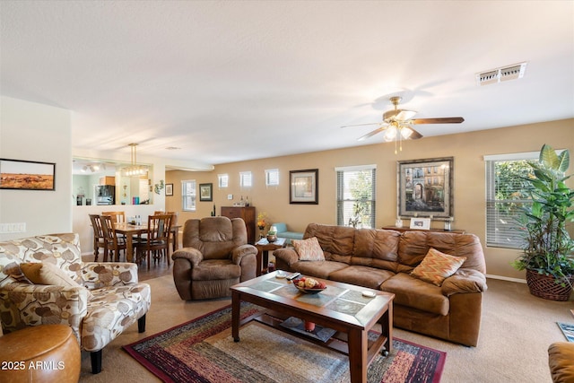 living room featuring ceiling fan and carpet