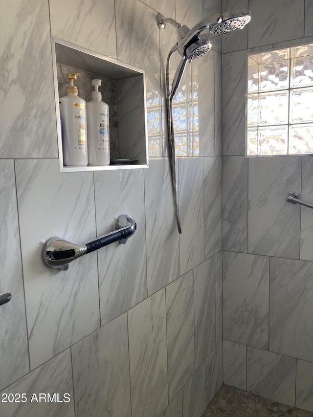 bathroom with a tile shower