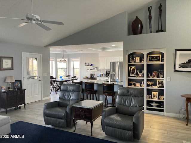 living room with ceiling fan, sink, and lofted ceiling