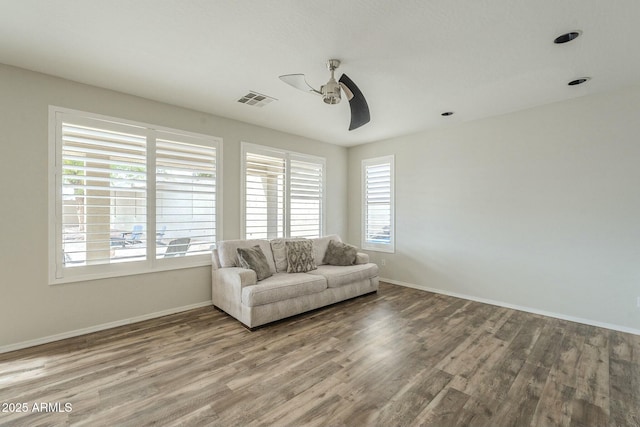 unfurnished room featuring a wealth of natural light, visible vents, and wood finished floors