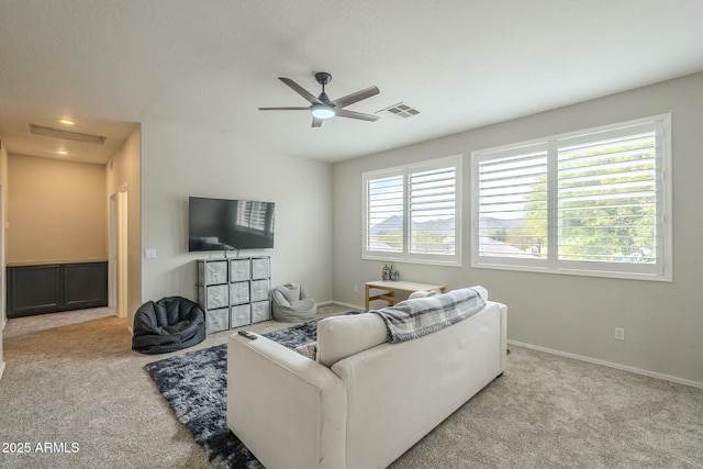 carpeted living room featuring plenty of natural light, baseboards, and visible vents