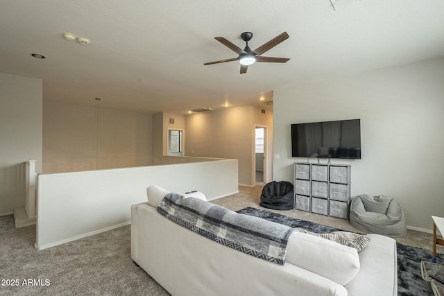 living room with baseboards, carpet, lofted ceiling, and ceiling fan