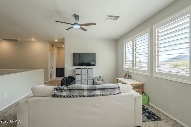 living room featuring visible vents, baseboards, and carpet