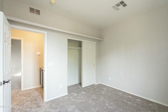 unfurnished bedroom featuring carpet flooring, baseboards, and visible vents