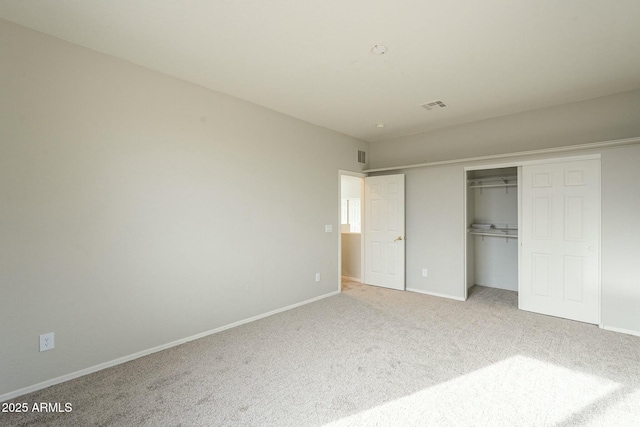 unfurnished bedroom featuring baseboards, visible vents, a closet, and light carpet