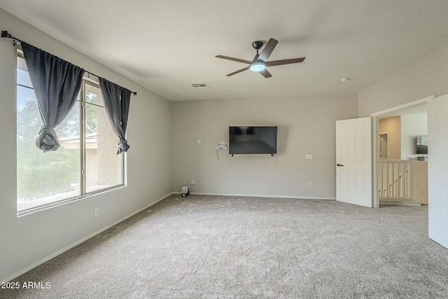 unfurnished living room with visible vents, baseboards, ceiling fan, and carpet floors