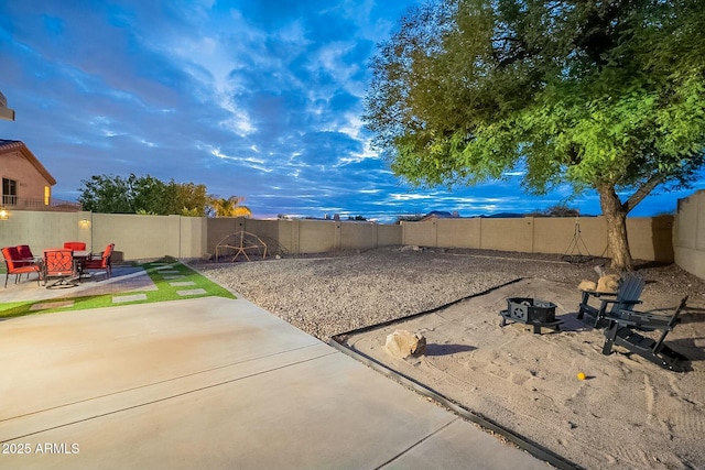 view of yard featuring a patio, a fire pit, and a fenced backyard