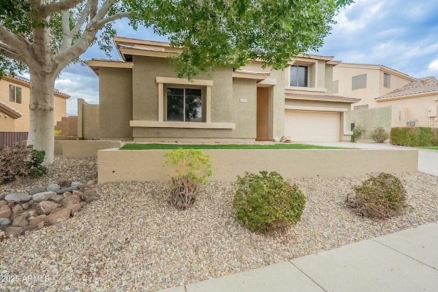 view of front of home featuring an attached garage and stucco siding