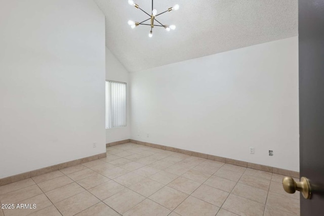 tiled spare room with an inviting chandelier, high vaulted ceiling, and a textured ceiling