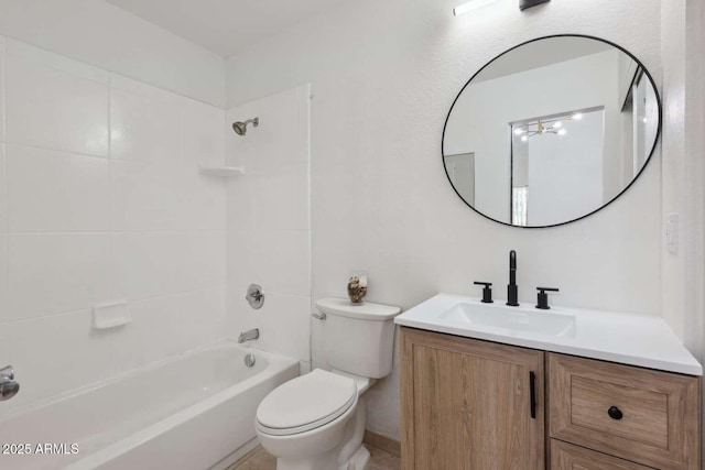 full bathroom featuring tiled shower / bath, vanity, and toilet