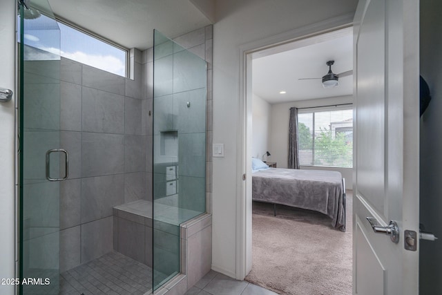bathroom with connected bathroom, a ceiling fan, tile patterned floors, and a stall shower