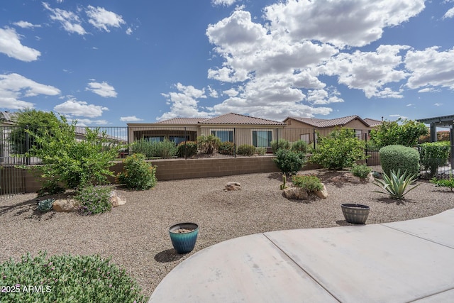 view of front of property with fence and a tile roof