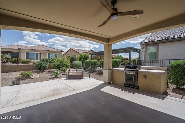 view of patio featuring grilling area, an outdoor living space, a ceiling fan, exterior kitchen, and a fenced backyard