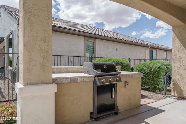 view of patio featuring a grill, fence, and area for grilling
