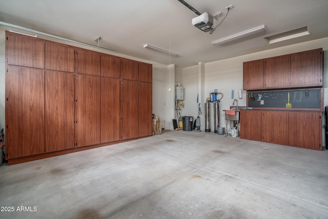 garage featuring a garage door opener and water heater