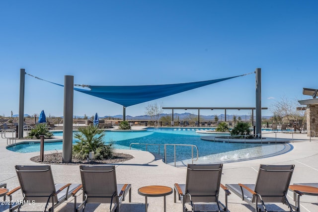 pool featuring a mountain view and a patio area