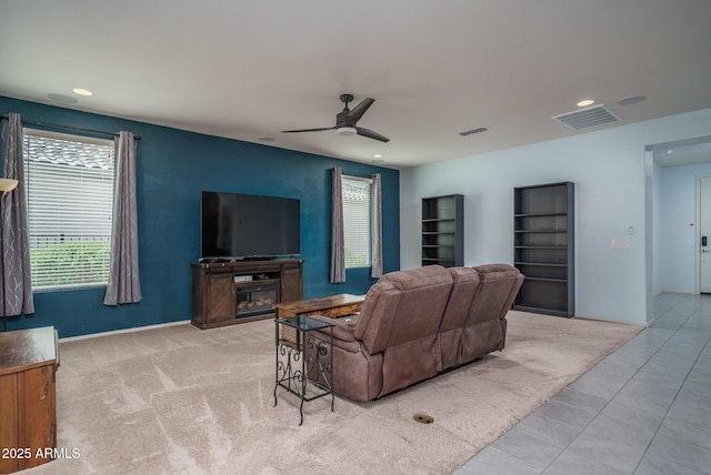 tiled living area featuring recessed lighting, visible vents, and a healthy amount of sunlight