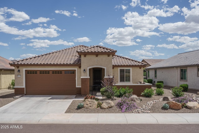 mediterranean / spanish-style house with a tiled roof, a garage, driveway, and stucco siding