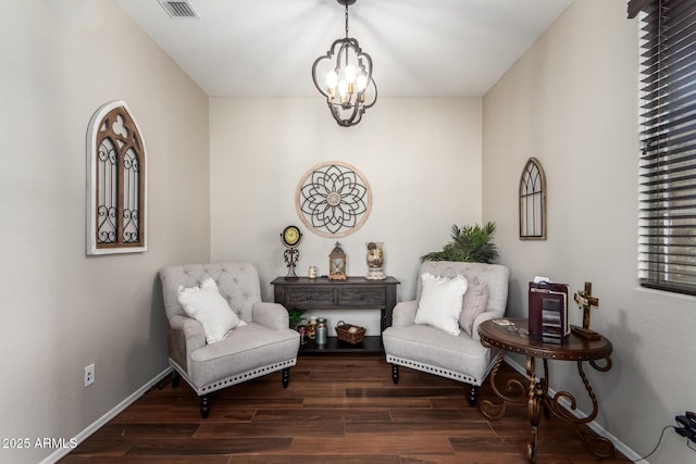 sitting room featuring visible vents, dark wood finished floors, baseboards, and an inviting chandelier