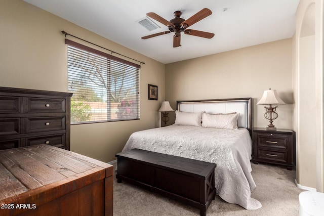 bedroom with ceiling fan, baseboards, visible vents, and light colored carpet