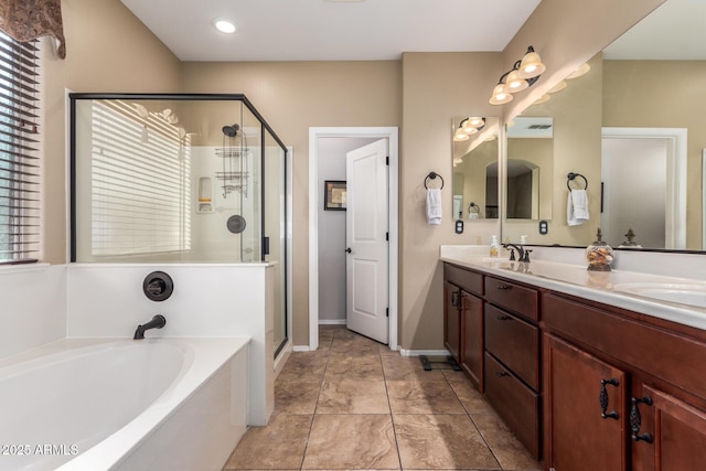 full bath with a garden tub, a sink, a shower stall, and double vanity