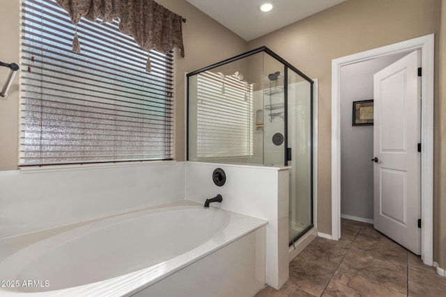 full bathroom with a stall shower, a bath, and recessed lighting