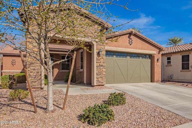 view of front of property featuring a garage, driveway, a tile roof, and stucco siding