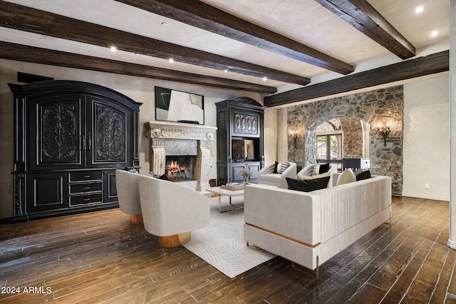 living room with dark wood-type flooring, a high end fireplace, and beamed ceiling