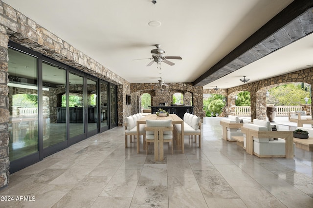 view of patio / terrace featuring ceiling fan and exterior bar