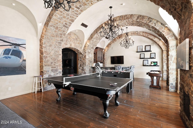 recreation room with lofted ceiling, an inviting chandelier, and dark hardwood / wood-style floors