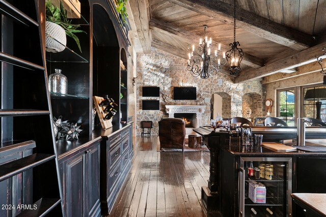 dining space with a wealth of natural light, vaulted ceiling with beams, a chandelier, and dark hardwood / wood-style floors