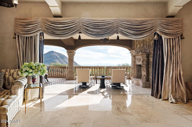 interior space featuring an outdoor stone fireplace and a mountain view