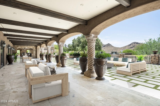 view of patio / terrace with an outdoor living space and a mountain view