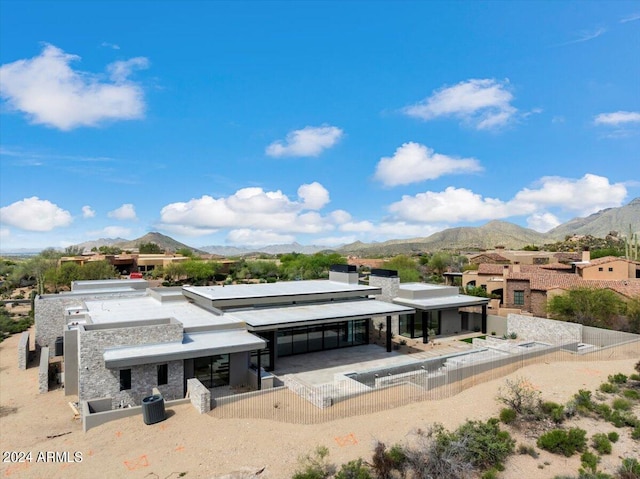 back of house with a mountain view