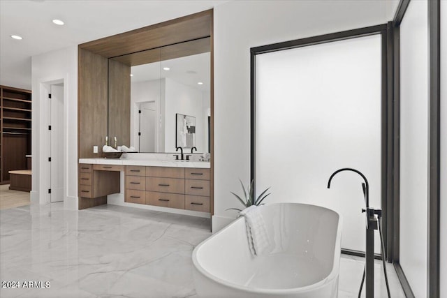 bathroom with a bath to relax in, tile flooring, and oversized vanity