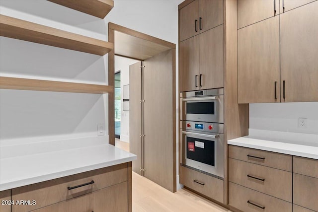 kitchen featuring light wood-type flooring and double oven