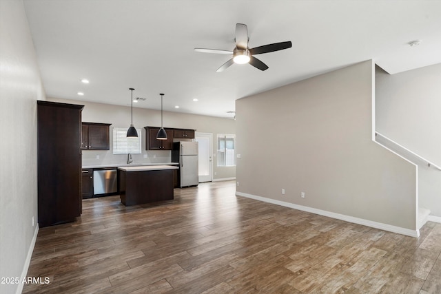 3010 N 37th St Unit 6, Phoenix, AZ 85018 - kitchen with appliances with stainless steel finishes, dark brown cabinetry, a kitchen island, open floor plan, and ceiling fan