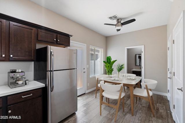 3010 N 37th St Unit 6, Phoenix, AZ 85018 - kitchen featuring freestanding refrigerator, dark brown cabinets, a ceiling fan, light countertops, and baseboards