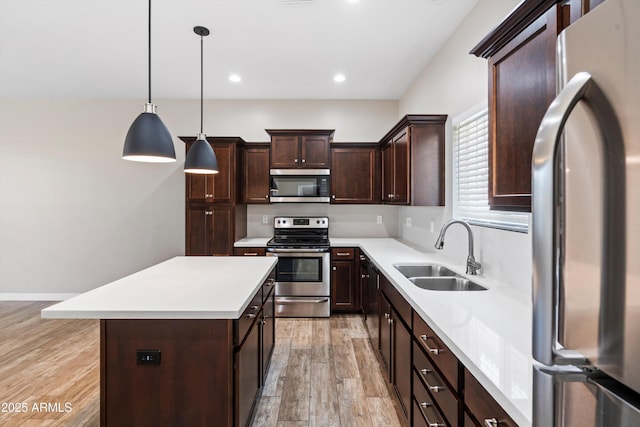 3010 N 37th St Unit 6, Phoenix, AZ 85018 - kitchen featuring appliances with stainless steel finishes, a sink, light wood finished floors, light countertops, and dark brown cabinets