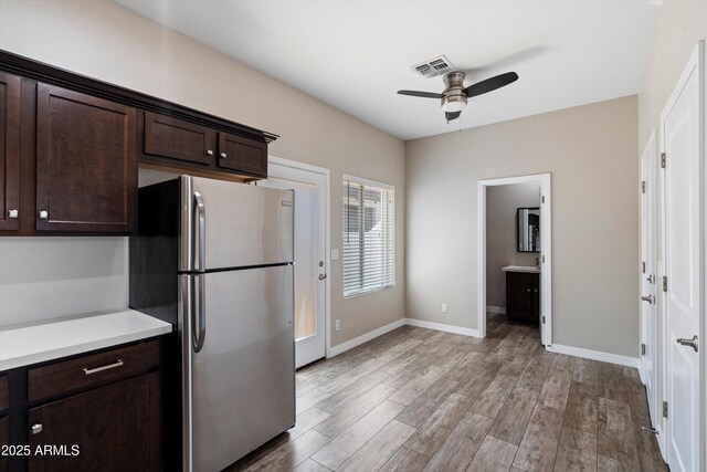 3010 N 37th St Unit 6, Phoenix, AZ 85018 - kitchen with freestanding refrigerator, dark brown cabinets, a ceiling fan, light wood-style floors, and light countertops