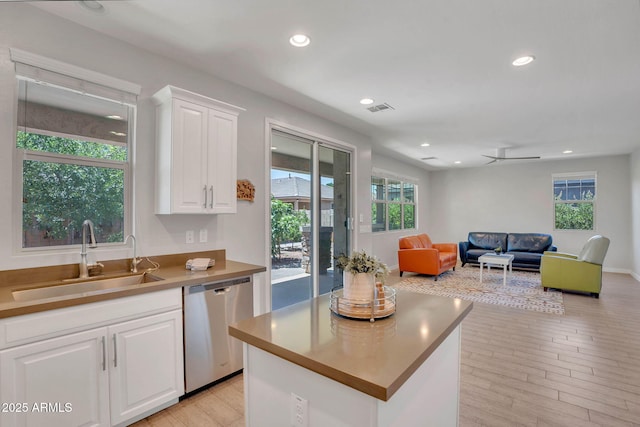 242 N Crosscreek Dr, Chandler, AZ 85225 - kitchen with dishwasher, a sink, white cabinetry, light wood finished floors, and open floor plan