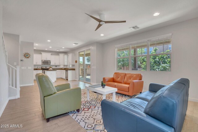 242 N Crosscreek Dr, Chandler, AZ 85225 - living room featuring baseboards, ceiling fan, light wood-style flooring, recessed lighting, and stairway