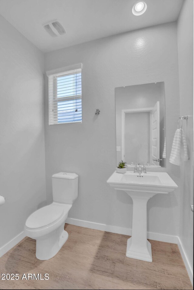 242 N Crosscreek Dr, Chandler, AZ 85225 - bathroom featuring toilet, wood finished floors, and baseboards